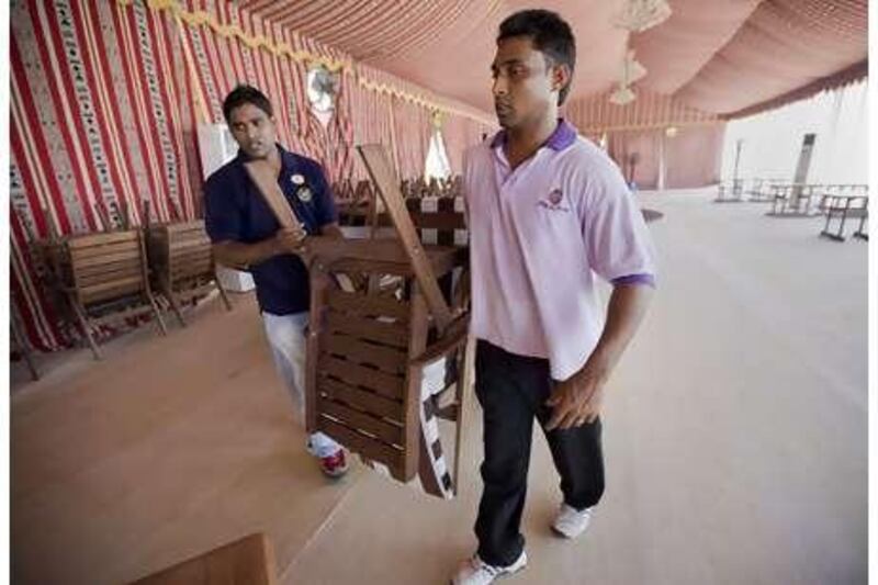 Employees at the Sheraton Abu Dhabi Hotel and Resort near the mina prepare a tent that will be hosting Ramadan festivities.