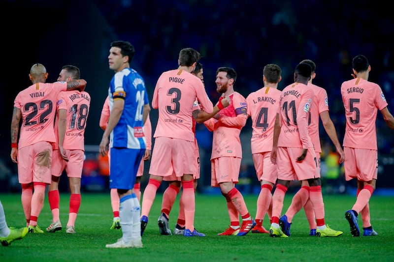 Lionel Messi and his teammates celebrate after he scored against Espanyol. AP Photo