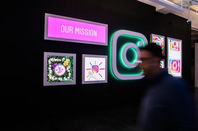 An employee walks past signage and photograph displayed at the Instagram Inc. office in New York, U.S., on Monday, June 4, 2018. Once, Instagram was a simple photo-sharing app, a way for iPhone shutterbugs to show off their latest cool pics. Now, its visual nature and 1 billion active users have sellers salivating over its potential as a place to sell everything from dresses to furniture. Photographer: Jeenah Moon/Bloomberg