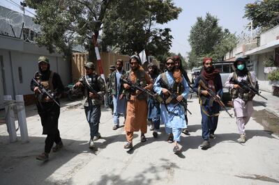 FILE - In this Wednesday, Aug.  18, 2021 file photo, Taliban fighters patrol in the Wazir Akbar Khan neighborhood in the city of Kabul, Afghanistan.  AP