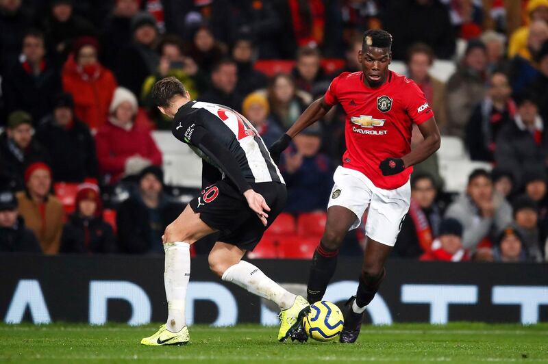 Manchester United's Paul Pogba, right, and Newcastle United's Florian Lejeune vie for the ball. PA
