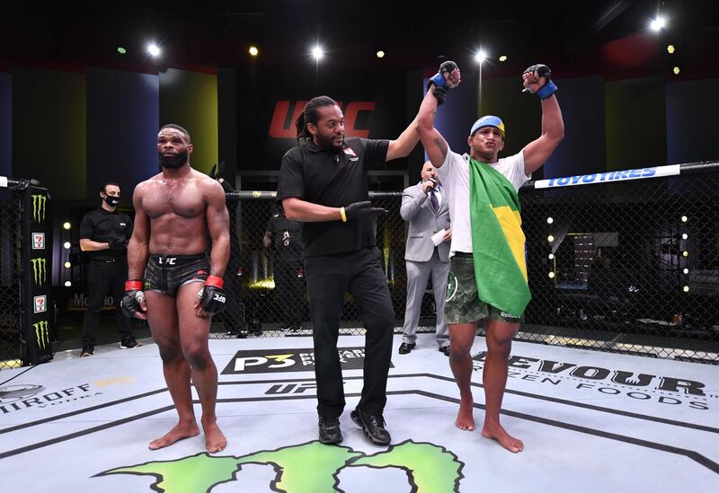 Gilbert Burns of Brazil (blue gloves) after his victory over Tyron Woodley. Zuffa