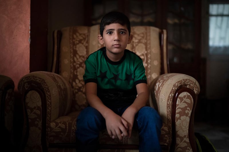 8-year-old Mohamed al-Dalo sits in his living room as he waits for breakfast before going to school in Gaza City. Ever since Hamas launched demonstrations in March against Israel's blockade of Gaza, children have been a constant presence in the crowds. Since then, U.N. figures show that 948 children under 18 have been shot by Israeli forces and 2,295 have been hospitalized, including 17 who have had a limb amputated.  AP