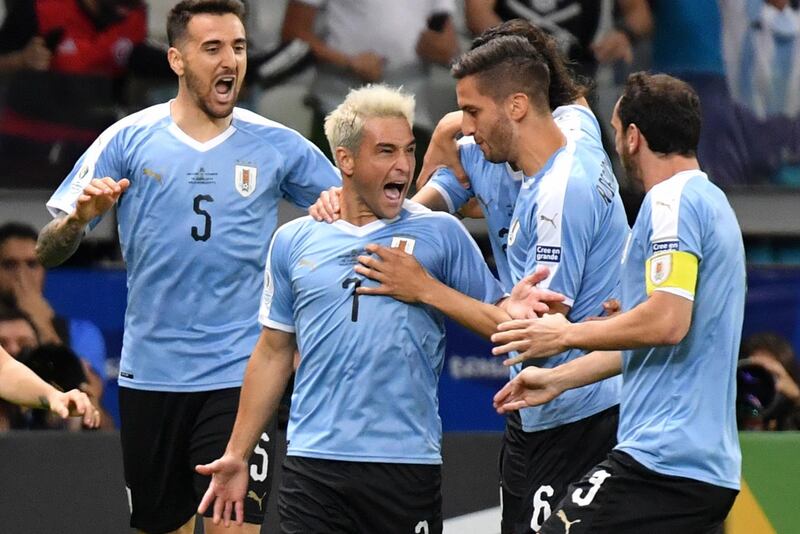 Uruguay's Nicolas Lodeiro (2-L) celebrates with teammates after scoring against Ecuador during their Copa America football tournament group match at the Mineirao Stadium in Belo Horizonte, Brazil.  AFP