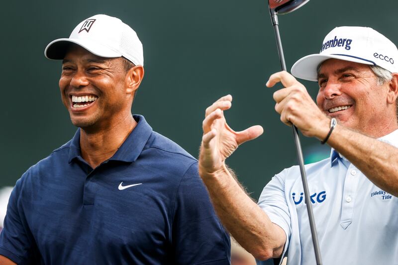 Tiger Woods and Fred Couples share a joke on the eighth fairway during practice for The Masters. EPA