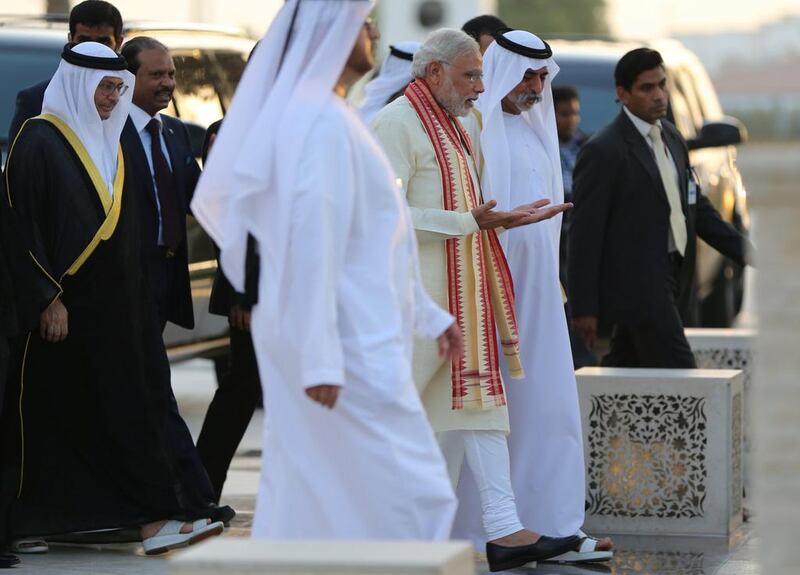 Mr Modi walks towards the grave of the UAE’s founder Sheikh Zayed, next to Sheikh Nahyan bin Mubarak. Kamran Jebreili / AP Photo