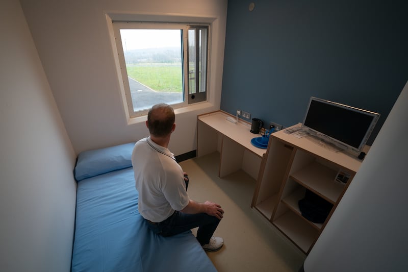 A prisoner sits in a cell at category C prison HMP Five Wells in Wellingborough, England. PA