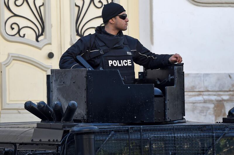 A Tunisian policeman stands guard in central Tunis during a rally marking the ninth anniversary of the 2011 uprising on Habib Bourguiba Avenue on January 14, 2020.  / AFP / FETHI BELAID
