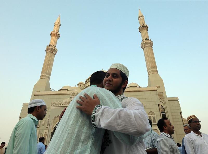 People greet each other after Eid prayers at the Al Noor Mosque in Sharjah in 2016. Satish Kumar / The National
