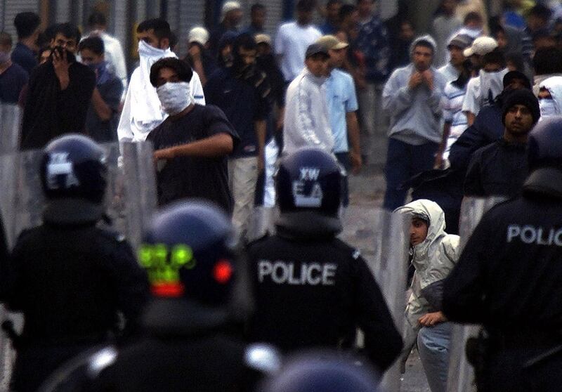 Youths confront police during rioting in Bradford, 200 miles (320 km) north of London, on the night of July 7, 2001.  Asian and white youths armed with petrol bombs and baseball bats clashed with police in the industrial city of Bradford on Sunday as northern England suffered a renewed outbreak of race rioting. Reuters