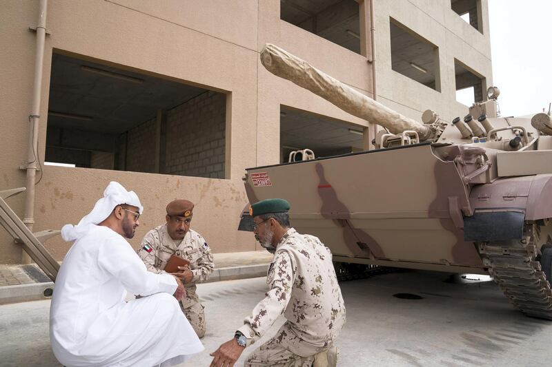 AL DHAFRA REGION, ABU DHABI, UNITED ARAB EMIRATES - April 08, 2018: HH Sheikh Mohamed bin Zayed Al Nahyan Crown Prince of Abu Dhabi Deputy Supreme Commander of the UAE Armed Forces (L) inspects a vehicle, after attending a military exercise titled ‘Homat Al Watan 2 (Protectors of the Nation)’, at Al Hamra Camp. Seen with HE Lt General Hamad Thani Al Romaithi, Chief of Staff UAE Armed Forces (R).
 ( Mohamed Al Hammadi / Crown Prince Court - Abu Dhabi )
---