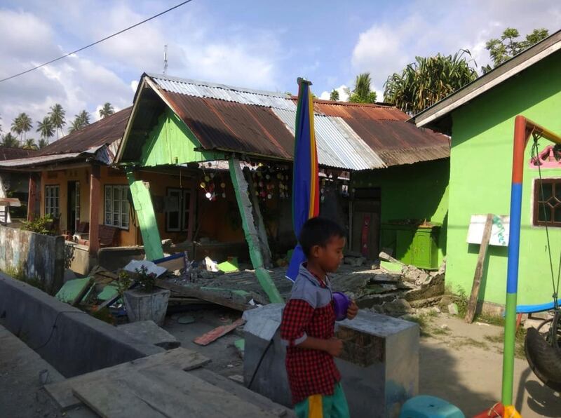 In this photo released by the Disaster Management Agency, a house sits damaged after a magnitude 6.1 earthquake early Friday, Sept. 28, 2018, in Donggala, central Sulawesi, Indonesia. Powerful earthquakes jolted the Indonesian island of Sulawesi on Friday, damaging houses and briefly triggered a tsunami warning. (Disaster Management Agency via AP)