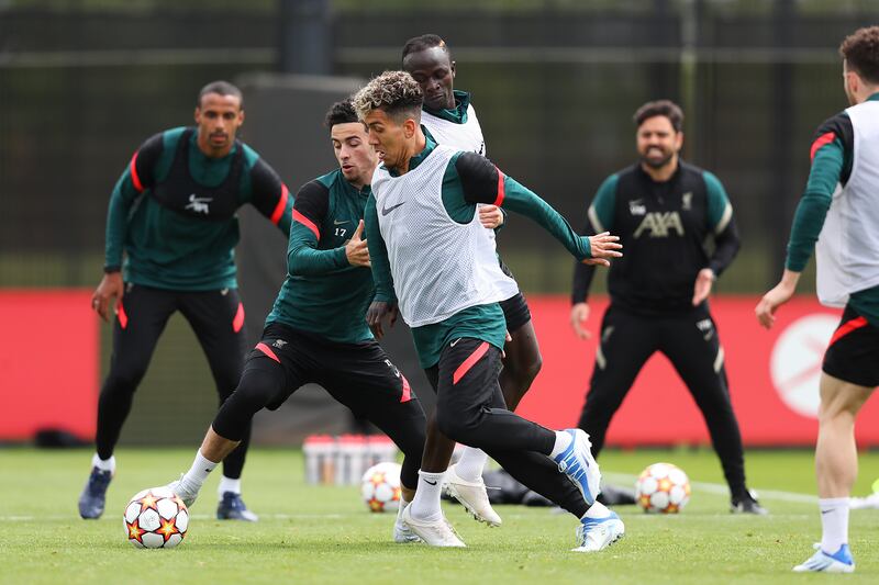 Roberto Firmino and Curtis Jones battle for the ball during training. Getty