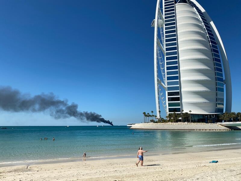 Smoke billows from a vessel on fire off the coast of Dubai. Farah Andrews / The National