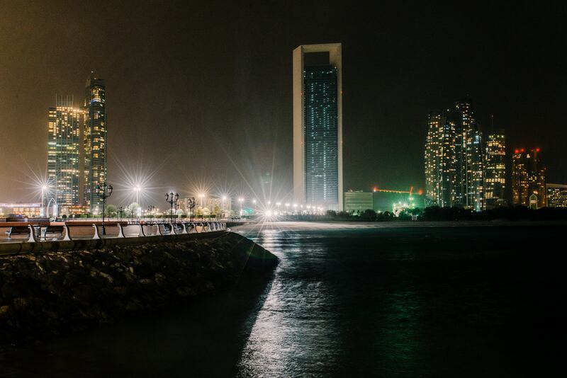 Abu Dhabi, UAE. March 25th 2017. The ADNOC building (C) with its main lights off during Earth Hour 2017 when, between 20:30 and 21:30, a WWF initiative encrouages residents and businesses to turn off their lights. In Abu Dhabi, Earth Hour achieved mixed results, with many buildings along the skyline keeping their lights on. Alex Atack for The National.  *** Local Caption ***  250317_EarthHour-9.jpg