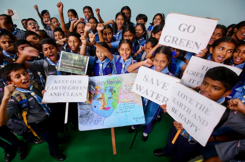 Schoolchildren shout slogans and display environment-themed placards in Bangalore. EPA