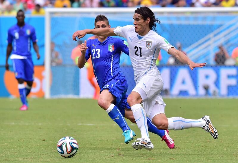 Uruguay midfielder Edinson Cavani, right, moves past Italy midfielder Marco Verratti during their 2014 World Cup Group D match at the Dunas Arena in Natal on June 24, 2014. Giuseppe Cacace / AFP