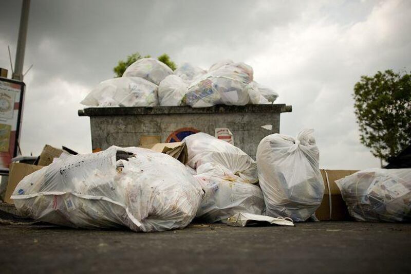 A dumpster at Marina Mall in Abu Dhabi overflows with rubbish.