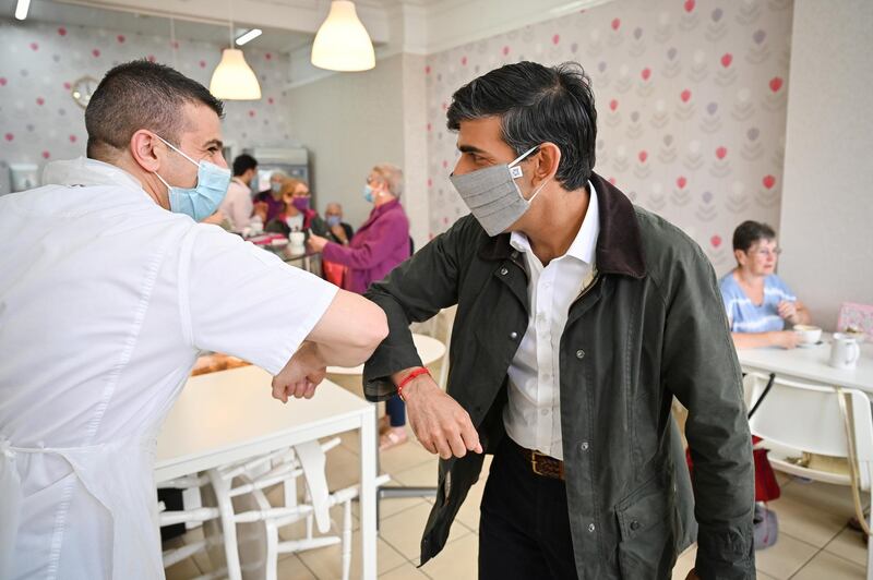 Britain's Chancellor of the Exchequer Rishi Sunak, wearing a face mask, meets with local business people during a visit to Rothesay, in the Isle of Bute, Scotland, Britain, August 7, 2020. Jeff J Mitchell/Pool via REUTERS