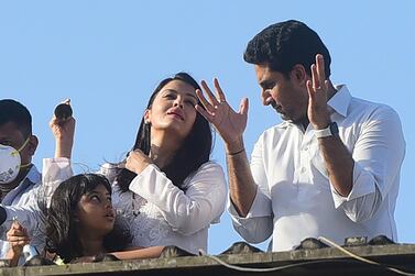 Bollywood actors Abhishek Bachchan and Aishwarya Rai Bachchan, along with their daughter Aaradhya, clap from atop a residential building to thank essential service providers during a one-day curfew imposed in Mumbai. AFP 