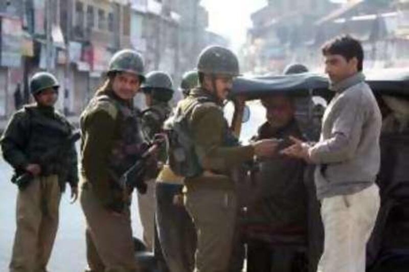Indian policemen check a passenger of an auto-rickshaw to questioning at a makeshift check-point in Kashmir's main city Srinagar where undeclared curfew restrictions were imposed Tuesday in the run up to the final phase of the general election to head off protests by Muslim separatists.

Credit: Tauseef Mustafa for The National 