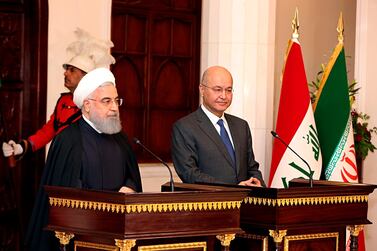 Iraqi President Barham Salih, right, and Iranian President Hassan Rouhani hold a press conference at Salam Palace in Baghdad. AP