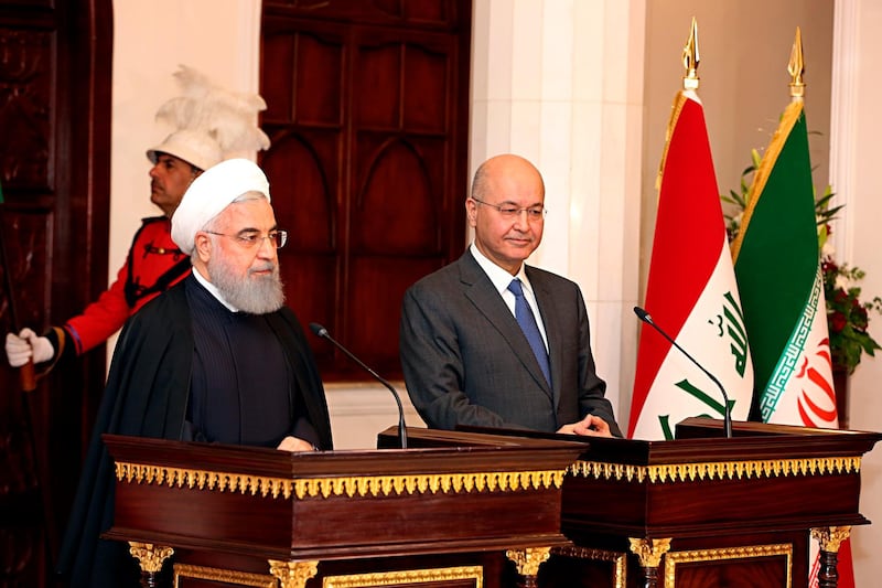 Iraqi President Barham Salih, right, and Iranian President Hassan Rouhani hold a press conference at Salam Palace in Baghdad, Iraq, Monday, March 11, 2019. Rouhani was in Baghdad on Monday, making his first official visit to the nation that Tehran once fought a bloody war against and later backed in the battle with the Islamic State group. (AP Photo/Khalid Mohammed)