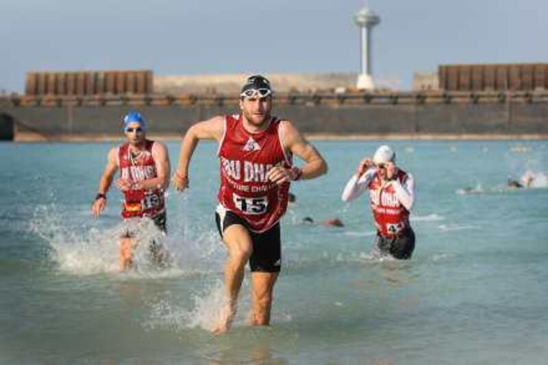 Abu Dhabi, United Arab Emirates --- December 4, 2009 --- Competitors in the 2009 Abu Dhabi Adventure Challenge ran along the Emirates Palace beach than took a swim and exited the water along the Cornich before jumping in kayaks during Day 1 of the race.  ( Delores Johnson / The National ) *** Local Caption ***  dj_04dec09_Abu Dhabi Challenge_018.jpg