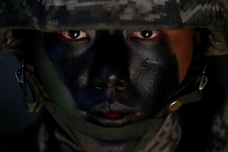 A South Korean marine in action during their regular drill on Yeonpyeong Island. Jeon Heon-Kyun / Reuters