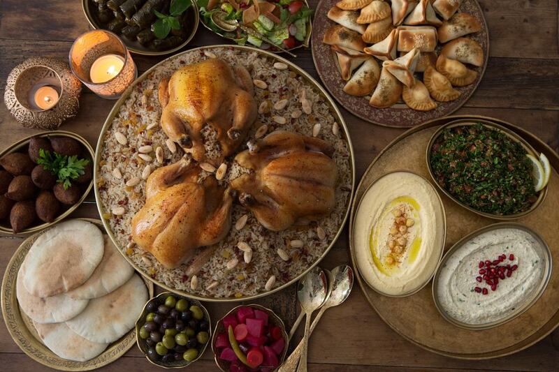 Chicken majboos, centre, surrounded by traditional mezze dishes. Getty Images 