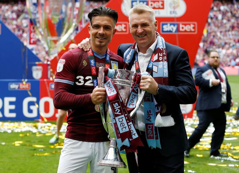 Aston Villa's Jack Grealish and manager Dean Smith pose with the trophy as they celebrate after winning the playoffs. Action Images via Reuters