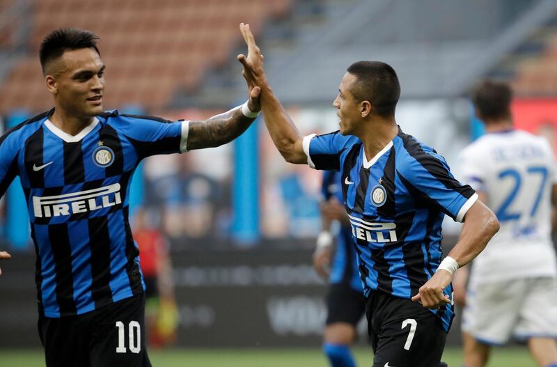 Inter Milan's Alexis Sanchez, right, celebrates with his teammate Lautaro Martinez after scoring his side's second goal. AP Photo