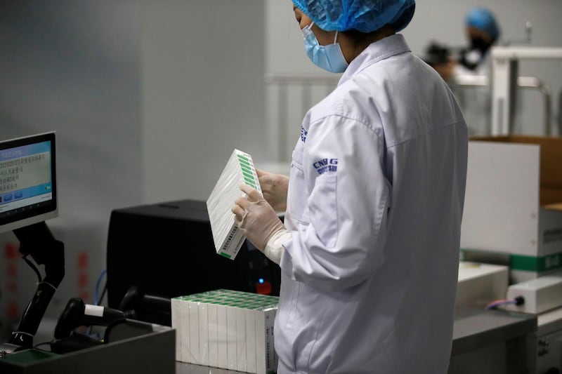 A worker checks a box of vaccine doses. Reuters