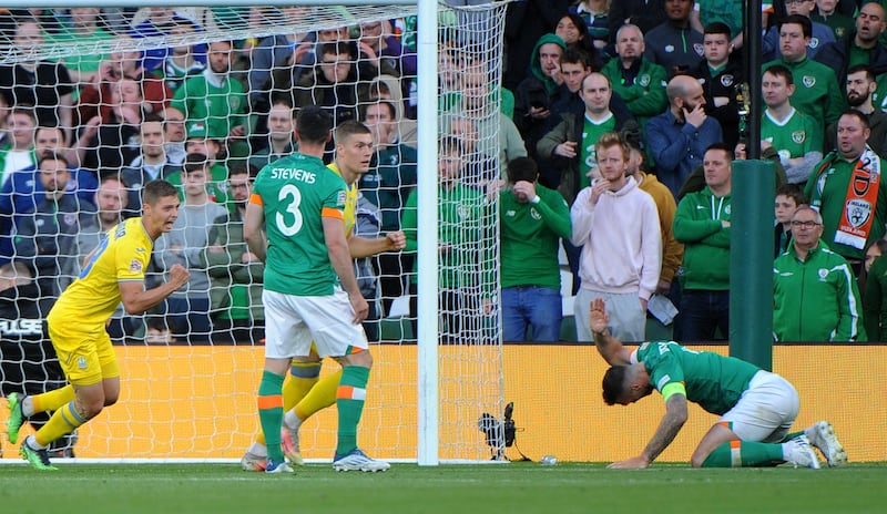 Viktor Tsygankov begins to celebrate after scoring against Ireland as Ireland captain Shane Duffy displays his frustration. EPA
