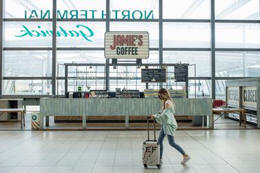 A traveller walks past the check-in desks at London Gatwick Airport. Concerns about catching the virus continue to affect decisions on travelling. Bloomberg