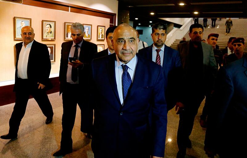 Iraq's new Prime Minister Adel Abdul-Mahdi, center, leaves the parliament building in Baghdad, Iraq, Tuesday, Oct. 2, 2018. Iraq's new president has tasked veteran Shiite politician Abdul-Mahdi with forming a new government nearly five months after national elections were held, state TV reported late Tuesday. (AP Photo/Karim Kadim)