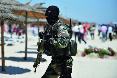 An armed guard patrols a beach in the aftermath of the attack in Sousse, Tunisia. Getty 