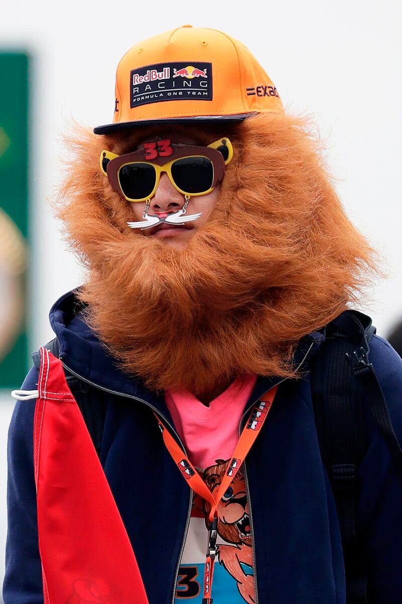 A fan is seen before the first practice round of the Formula One Japanese Grand Prix at the Suzuka circuit. Kiyoshi Ota / AFP Photo.