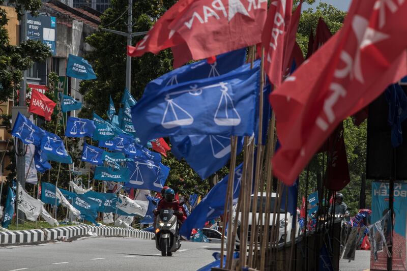 The campaign flags of Malaysia's ruling Barisan Nasional coalition, blue, and Mr Anwar's PH, red, in Kuala Lumpur. AP