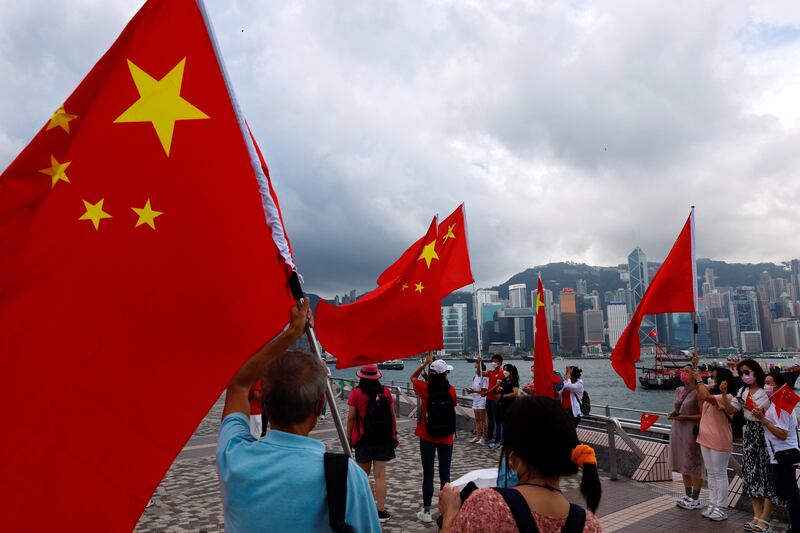 Supporters hold Chinese flags to celebrate the 24th anniversary of Hong Kong's return to Chinese rule in the former British colony last July. Reuters
