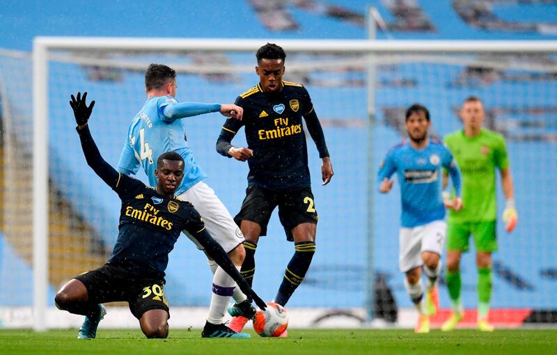 Arsenal's English striker Eddie Nketiah vies for the ball against Manchester City's French defender Aymeric Laporte. AFP