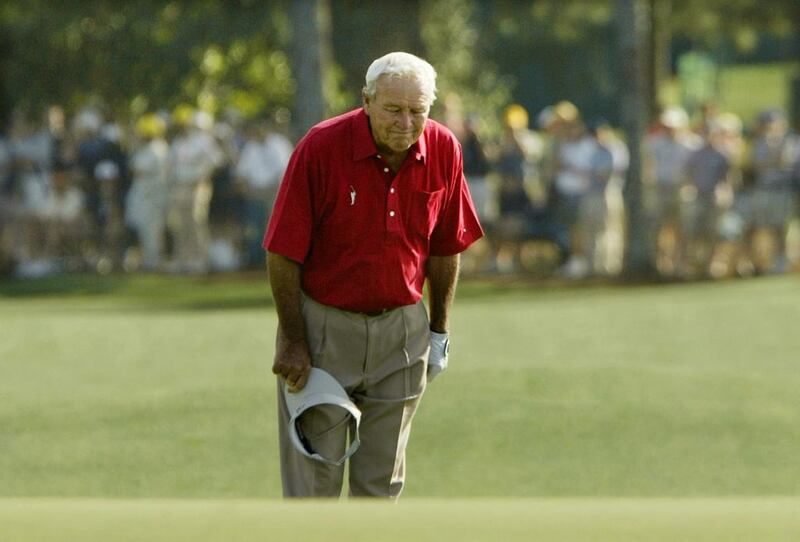 Four-time Masters champion Arnold Palmer pauses and bows to the gallery as he walks to the 18th green during his final competitive appearance in the Masters golf tournament at Augusta National Golf Club in Augusta, Georgia, on April 9, 2004. Palmer competed in the tournament 50 times. Kevin Lamarque / Reuters