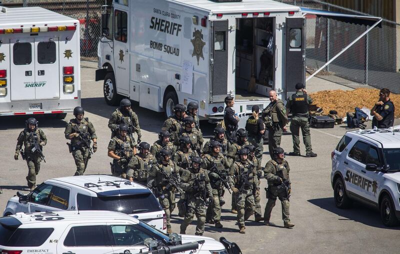 Tactical law enforcement officers move through the rail yard after a Valley Transportation Authority employee opened fire. The gunman is also dead, police said. AFP