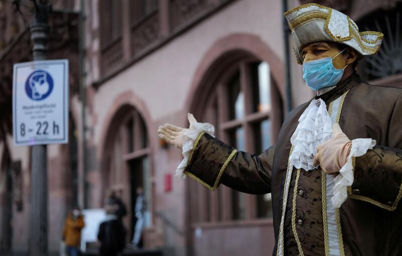 An actor in a historical costume wears a protective mask in Frankfurt, Germany. Reuters