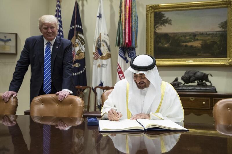 Sheikh Mohamed bin Zayed, Crown Prince of Abu Dhabi and Deputy Supreme Commander of the UAE Armed Forces, signs the guest book upon arriving at the White House for a meeting with US president Donald Trump on May 15, 2017. Ryan Carter / Crown Prince Court - Abu Dhabi