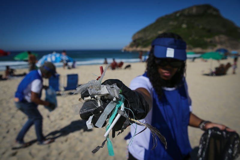 Volunteers clean the Recreio dos Bandeirantes beach in Rio de Janeiro, Brazil.  EPA