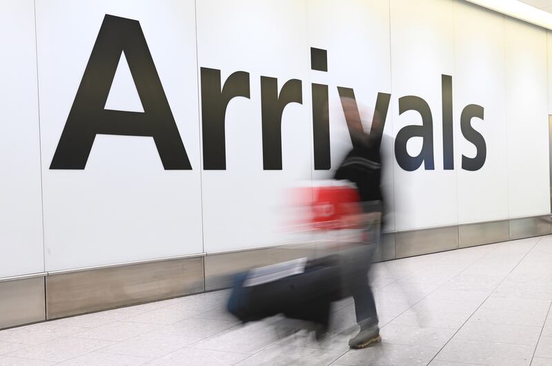 Travellers arrive at Heathrow Airport in London. EPA