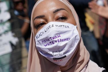 A Muslim woman wears a face mask that reads: "Black lives matter more than white feelings" at a protest rally against racism in Berlin, Germany. Getty Images