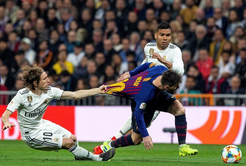 Barcelona's Lionel Messi, right, in action against Real Madrid's Luka Modric during the semi-final second leg of the Copa del Rey. Barcelona won the match at Madrid's Bernabeu 3-0 to advance 4-1 on aggregate. Reuters