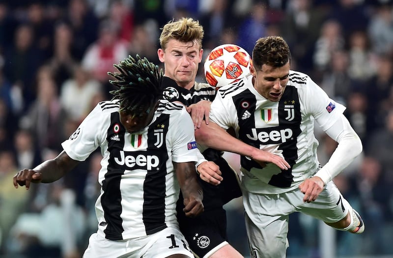 Juventus' Moise Kean and Cristiano Ronaldo in action with Ajax's Matthijs de Ligt. Reuters